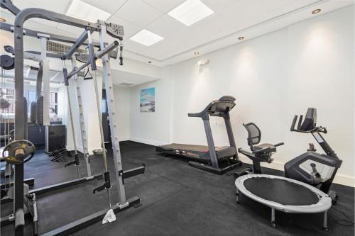 a gym with two tread machines and a treadmill at Roami at Sunny Isles in Miami Beach