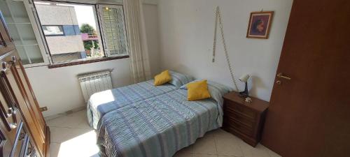 a small bedroom with a bed and a window at Casa Mirna in Carrara