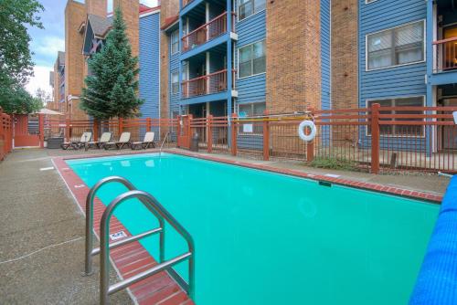 a small blue swimming pool in front of a building at River Mountain Lodge by Breckenridge Hospitality in Breckenridge