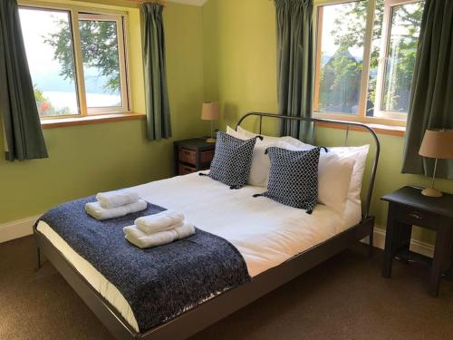 a bedroom with a bed with two towels on it at Spacious 4-Bed House in Lynton in Lynton