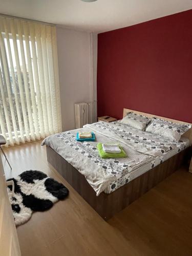 a bedroom with a bed and a dog laying on the floor at Apartament SweetHome Piața Unirii in Iaşi