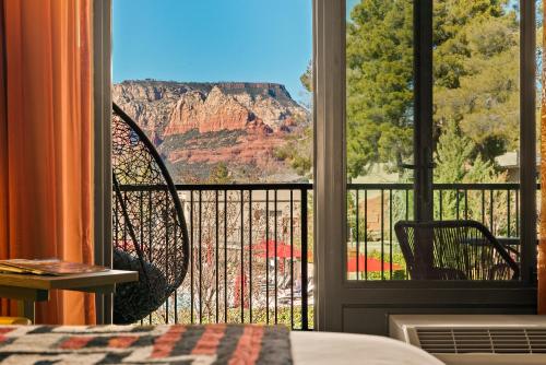 a bedroom with a view of the canyon from a window at Arabella Hotel Sedona in Sedona