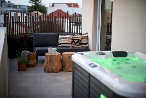 a patio with a hot tub and a couch at Ambient Living Lofts in Preveza