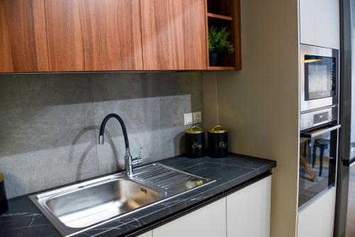 a kitchen with a sink and a microwave at Ambient Living Lofts in Preveza