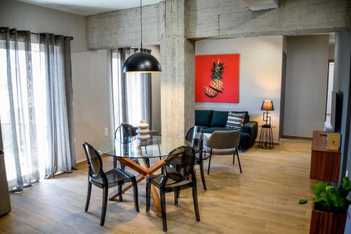 jadalnia ze szklanym stołem i krzesłami w obiekcie Ambient Living Lofts w Prewezie
