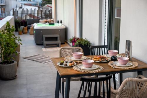 a wooden table with plates of food on it at Ambient Living Lofts in Preveza