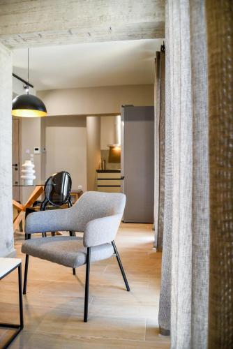 a living room with a chair and a table at Ambient Living Lofts in Preveza
