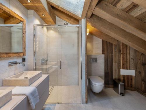 a bathroom with a shower and a sink and a toilet at Chalet Méribel, 6 pièces, 12 personnes - FR-1-566-43 in Les Allues