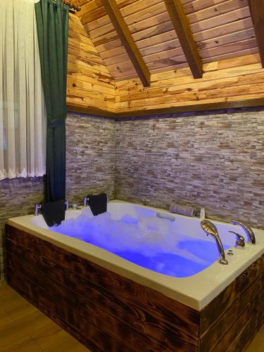 a large blue bath tub in a room at Zennat bungalov 