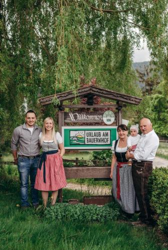 a group of people standing in front of a sign at Zauscherhof in Wildermieming