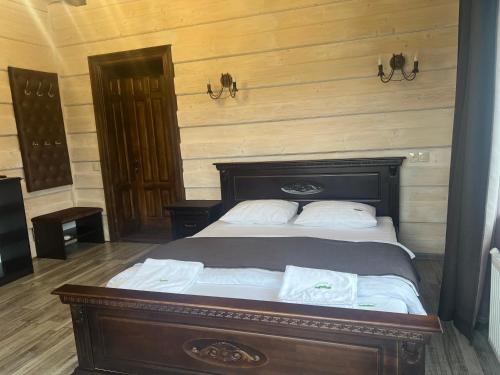 a bedroom with a bed with two white towels on it at Мелодія Гір Вид на гори in Vorokhta