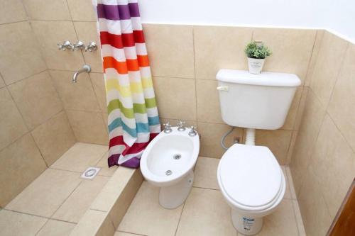 a bathroom with a toilet and a shower curtain at Ventanas al cerro recargado! in La Rioja
