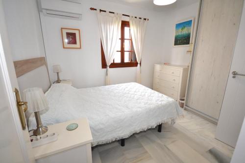 Schlafzimmer mit einem Bett, einem Waschbecken und einem Spiegel in der Unterkunft Bahia azul in Estepona