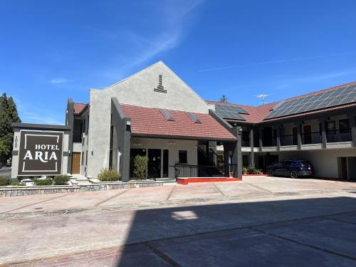 a building with a parking lot in front of it at Hotel Aria in Mountain View