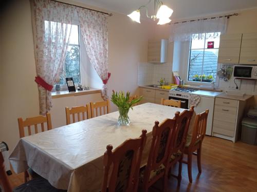 a kitchen with a table with a vase on it at POLANA in Leśna