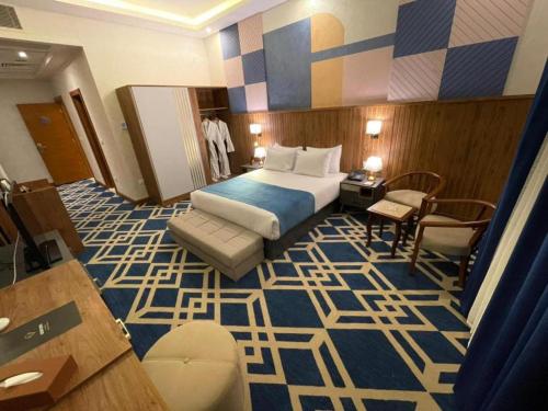 a hotel room with a bed and a chair at Golden Jewel Ismailia Resort in Ismailia