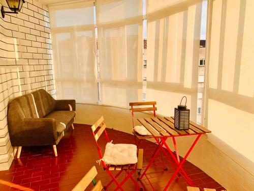a living room with a chair and a table at Family & Groups Space, Santiago Center - No Kitchen in Santiago de Compostela