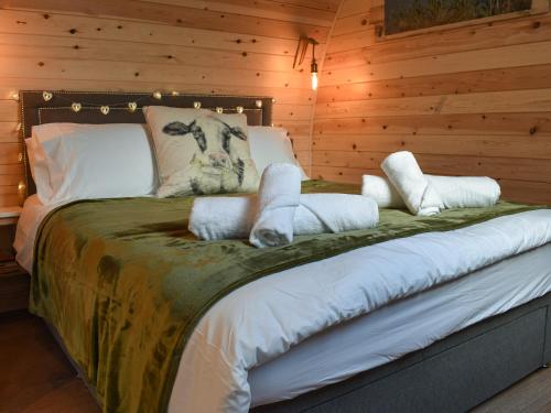 a bedroom with a bed in a wooden wall at Lakeview Lodge- Uk40692 in Crowhurst