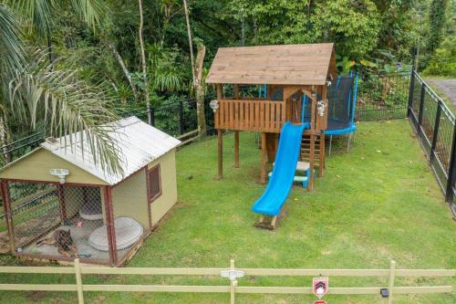 a small playground with a slide and a house at Vista Verde House w/Pool & WiFi in Paquita