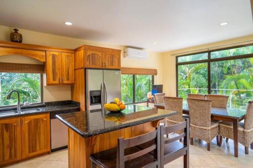 a kitchen with wooden cabinets and a table with fruit on the counter at Vista Verde House w/Pool & WiFi in Paquita