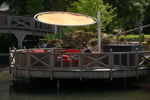 a woman sitting on a boat in the water at B&B De Rentmeesterhoeve in Reningelst