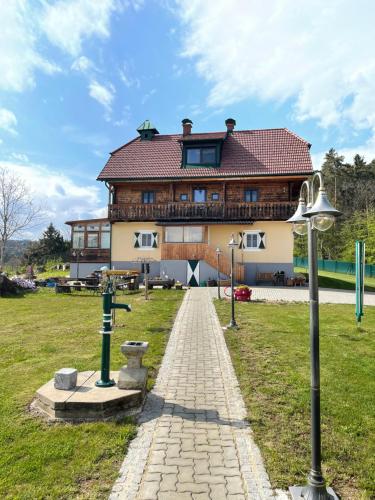 a large building with a pathway in front of it at Uriges Bauernhaus mit Blick auf Graz in Graz