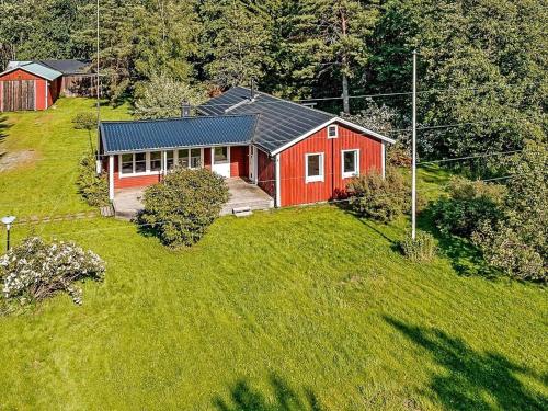 an aerial view of a red house on a green field at 4 person holiday home in ASKERSUND-By Traum in Askersund