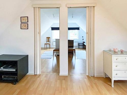 a living room with a television and a table at 9 person holiday home in Ljungbyhed-By Traum in Ljungbyhed