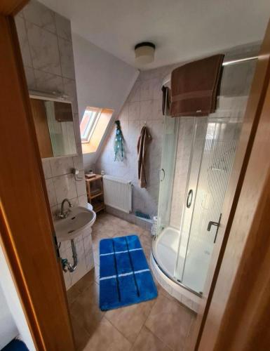 a bathroom with a shower and a tub and a sink at Monteurs-Ferienwohnung in Emden