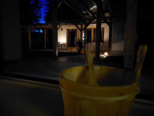 a yellow cup with a banana in the dark at Villa Quality Wellness in Dozmat