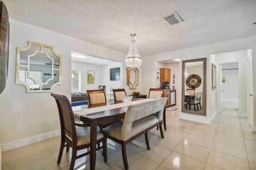 a dining room and living room with a table and chairs at Home Near Weeki Wachee, King Bed, Huge Backyard in Spring Hill