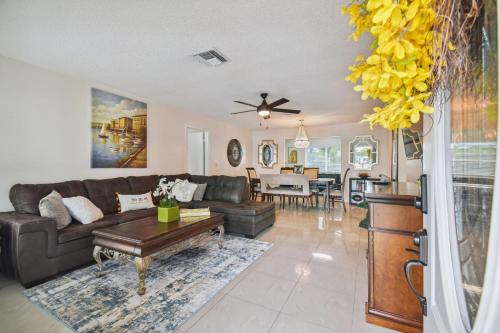 a living room with a couch and a table at Home Near Weeki Wachee, King Bed, Huge Backyard in Spring Hill
