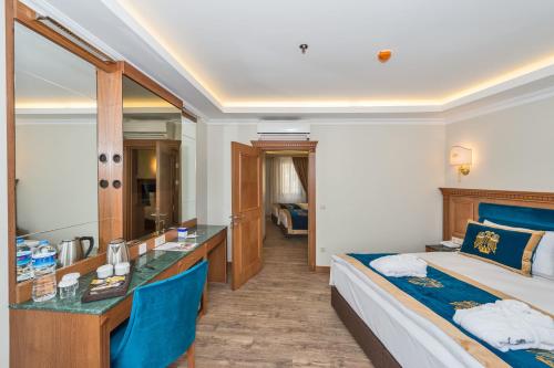 a hotel room with a bed and a desk at The Byzantium Suites Hotel & Spa in Istanbul