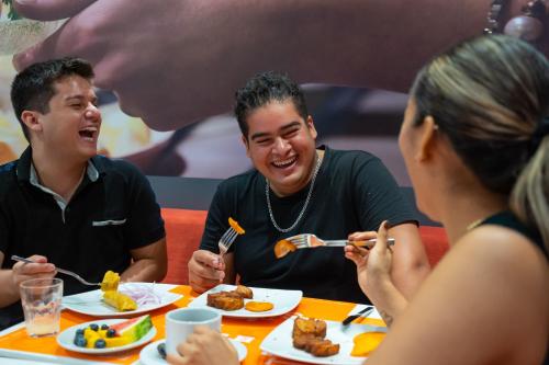 a group of people sitting around a table eating food at ibis Trujillo in Trujillo
