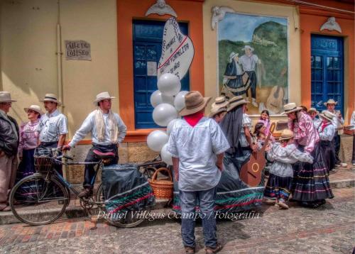 a group of people standing in front of a building at Hospedaje La Casona in Tabio