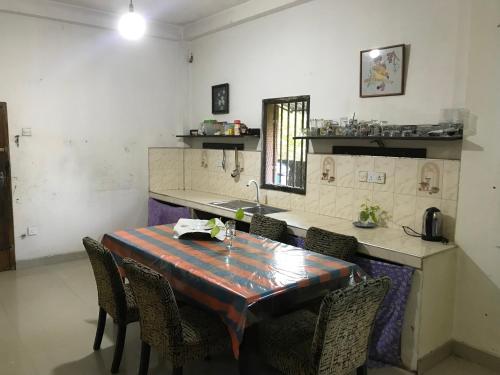 a kitchen with a table and chairs and a counter at Menara Villa in Kamburugamuwa