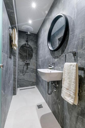 a bathroom with a sink and a mirror at Domus Victoria IΙ in Corfu