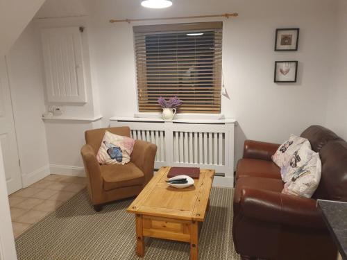 a living room with two chairs and a coffee table at Lealt Falls House in Culnacnoc