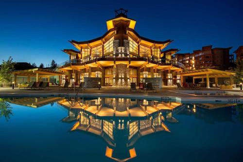 a large building with a pool in front of it at Stay In The Okanagan - Copper Sky, West Kelowna in West Kelowna