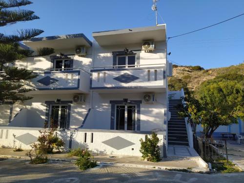 a white building with stairs in front of it at Dionisia apartments 8 in Kos