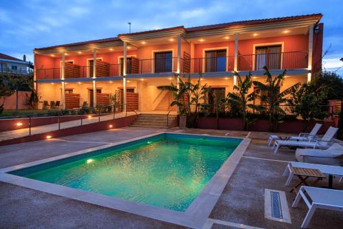 a house with a swimming pool in front of it at Samari Afitos in Afitos