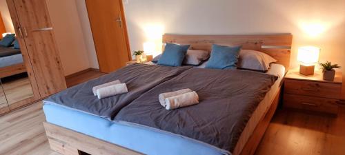 a large bed with two pillows on it in a bedroom at Apartma Metka Bovec in Bovec