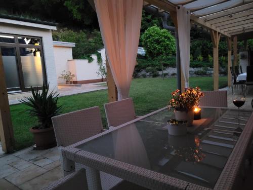 a table and chairs on a patio with a tent at Villa Quality Wellness in Dozmat