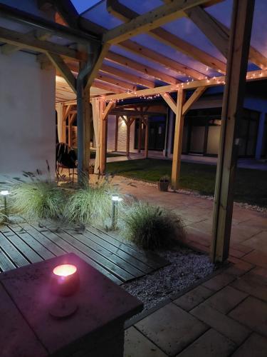 a candle sitting on a table in a patio at night at Villa Quality Wellness in Dozmat