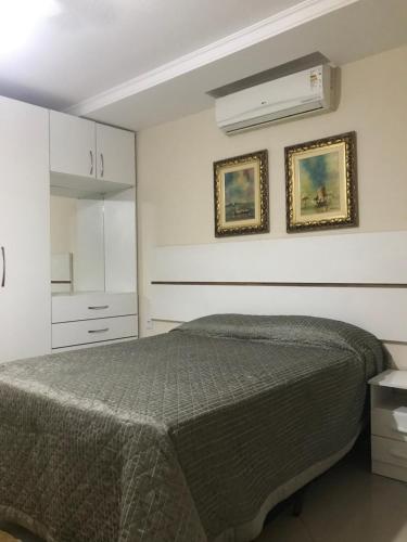 a bedroom with a bed and a white cabinet at Pousada & Eventos Casa do Jova - Raposo RJ in Raposo