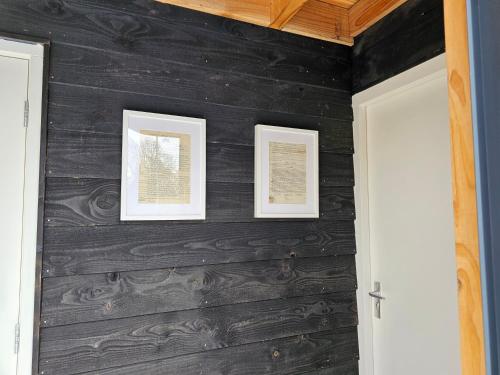 a room with two framed pictures on a wall at Ham Annex met privé jacuzzi in Almelo