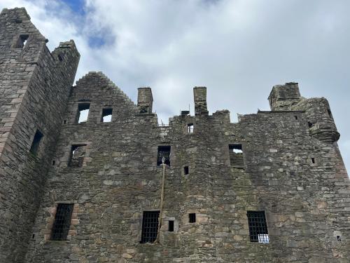 a large stone castle against a blue sky at The Blue Door in Kirkcudbright