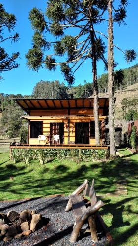 a log cabin with a bench in front of it at Sentiero Cabanas Boutique in Urubici