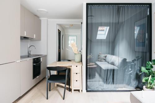 a kitchen with a desk and a chair in a room at Stay Fløyen in Bergen