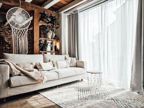 a living room with a couch and a large window at Cloud 9 in Ralingen